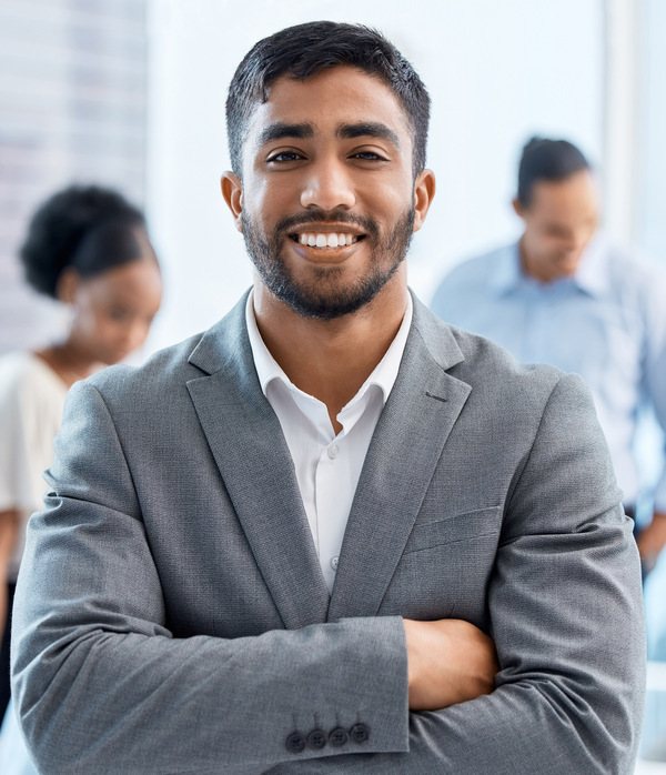 Coaching, motivation and happy, proud business leader in meeting with diverse colleagues in an office. Portrait male smiling during training with workers, discussing improvement and strategy planning.